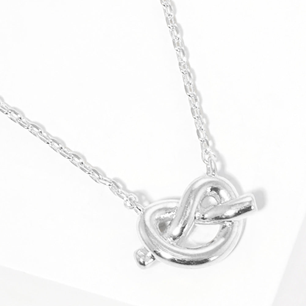 White Gold Dipped Knotted Heart Pendant Necklace features a delicate and intricate design perfect for any occasion. The heart pendant is coated in lustrous gold, adding a touch of elegance to the piece. Make a statement with this beautiful necklace that is both stylish and timeless.