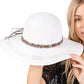 White Wide Brim Straw Sun Hat with Evil Eye and Multi Design Band offers stylish sun protection with its unique evil eye and multi-design band. Its wide brim provides ample shade while the evil eye brings a touch of charm. Stay safe from the sun while adding a fashionable touch to your outfit. 
