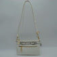 White This functional crossbody bag is designed for organized everyday use, featuring a textured exterior equipped with multiple secure storage compartments. The front panel includes a convenient horizontal zippered pocket accented with an oversized metallic zipper pull, situated beneath a decorative horizontal band detailed with metallic studs and loops.
