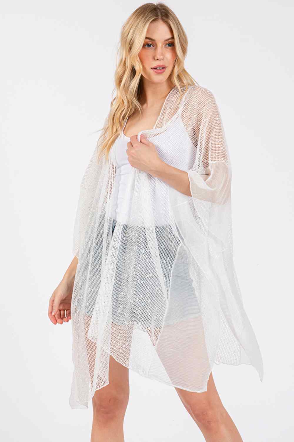 White Elevate your beach look with this shimmering sequin mesh cover up. Crafted from lightweight polyester, it drapes beautifully over your swimwear while catching the light with every movement. The solid mesh design offers a sophisticated, see-through aesthetic perfect for poolside strolls or beachside moments. Measuring 41" x 31", it provides comfortable coverage without bulk. An effortless way to transition from water to shore in style.