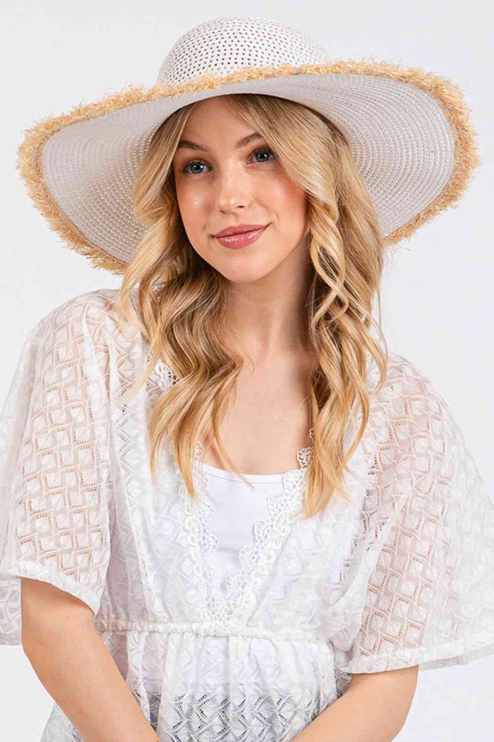 White Embrace effortless summer style with this frayed-edge two-tone floppy straw hat. Crafted from 100% paper, it offers a lightweight, breathable design perfect for sunny days. The wide brim provides excellent sun protection while the textured frayed edges add a relaxed, on-trend aesthetic.