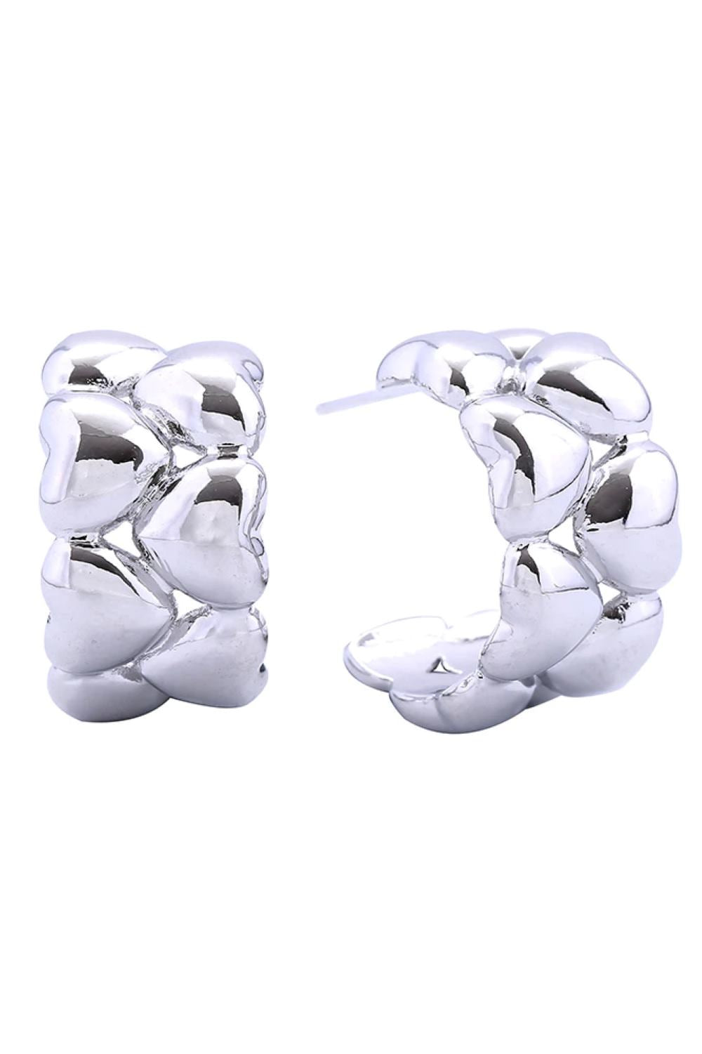 White Gold Delicate brass post earrings with a charming bumpy heart design, dipped in 14K gold and white finishes. Each earring measures 1.9cm in diameter, offering a subtle yet eye-catching look. Hypoallergenic construction makes them perfect for sensitive ears. Lead and nickel compliant for safe, worry-free wear. An elegant addition to any jewelry collection.