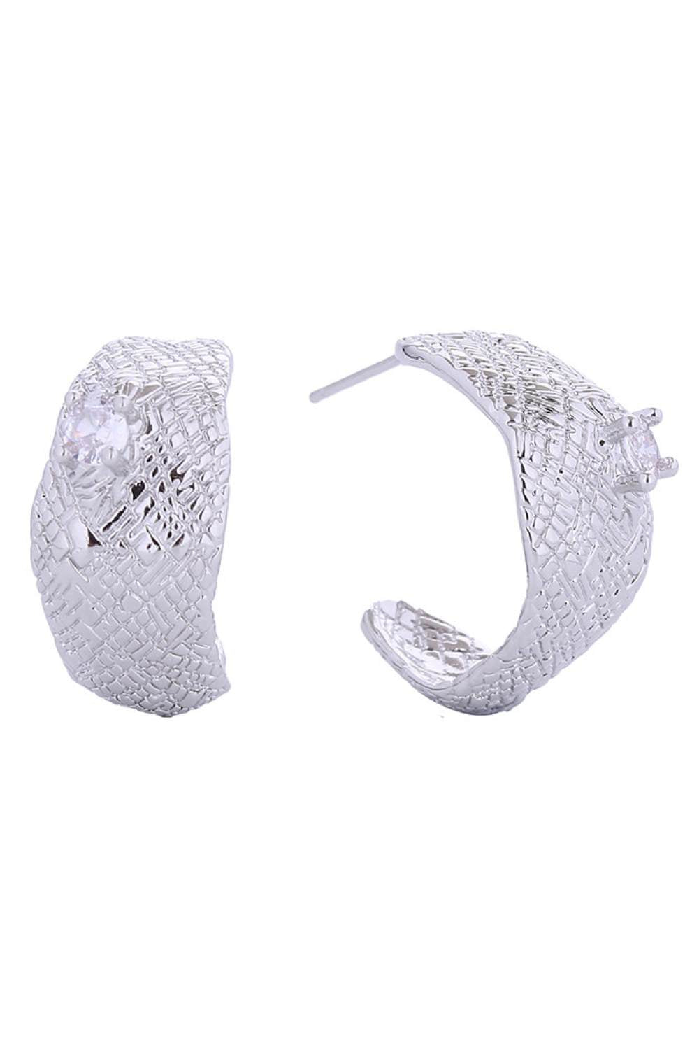 White Gold Elegant crescent-shaped post earrings featuring sparkling cubic zirconia accents. Crafted from brass with 14K gold or white gold dipping for a luxurious finish. Measuring 2.5cm, these hypoallergenic earrings are perfect for sensitive skin. Lead and nickel compliant for safe, everyday wear. Expertly made in Korea, these versatile studs add a touch of sophistication to any look.
