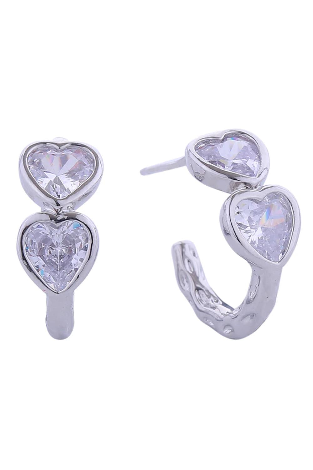White Gold Elegant 14K duo heart cubic zirconia post earrings crafted from hypoallergenic brass. Each earring features a delicate 1.8cm diameter design with sparkling CZ stones that catch the light beautifully. Lead and nickel compliant for safe, comfortable everyday wear. Perfect for adding a touch of sophistication to any look.