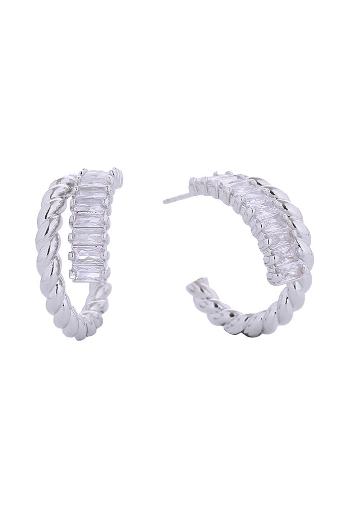 Elevate your everyday elegance with these stunning 14K Duo Swirl Pave CZ Hoop Earrings. Crafted from hypoallergenic brass and dipped in luxurious 14K gold or white gold, these earrings feature a sophisticated dual swirl design adorned with sparkling cubic zirconia pavé detailing. Measuring 2.2cm, they strike the perfect balance between statement and wearability. Made in Korea with meticulous attention to quality, these earrings are lead and nickel compliant, making them ideal for sensitive skin. Perfect for