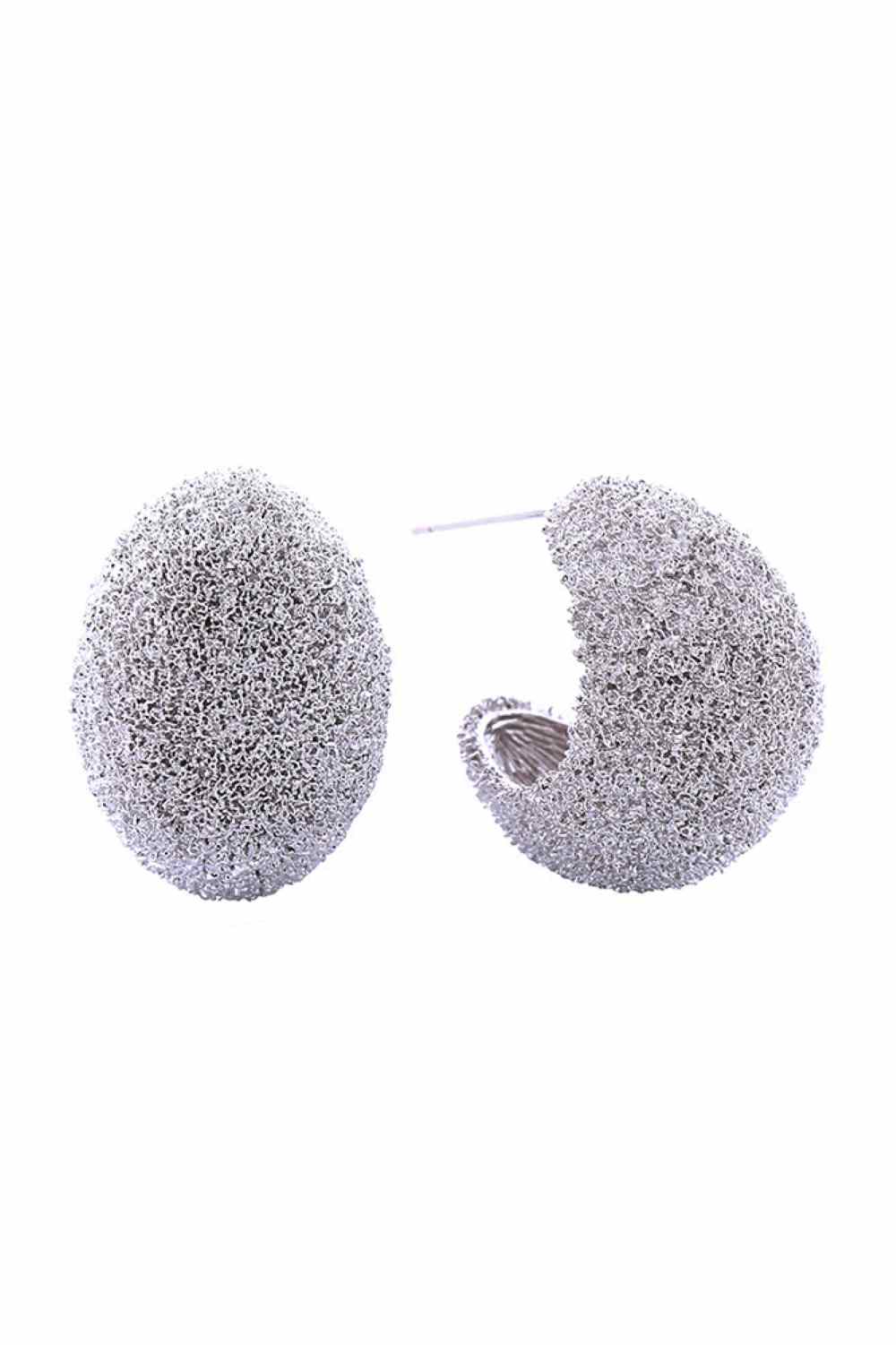 White Gold Elegant crescent-shaped post earrings featuring a delicate grain texture finish. Crafted from hypoallergenic brass with 14K gold and white dipping for a luxurious look. Each earring measures 2.6cm in diameter, offering a refined statement without overwhelming the ear. Lead and nickel compliant, making them safe for sensitive skin. Perfect for everyday wear or special occasions.