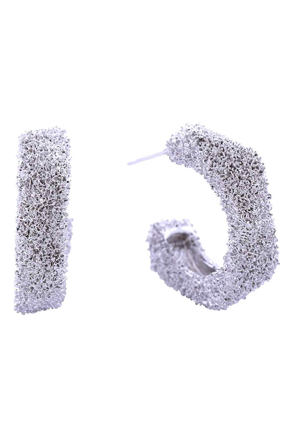 White Gold Elegant post earrings crafted in brass with a luxurious 14K gold and white dipped finish. The textured grain surface adds sophisticated dimension to these versatile studs. Measuring 2.2cm in diameter, they're the perfect size for everyday wear or special occasions. Hypoallergenic design makes them ideal for sensitive skin. Lead and nickel compliant, ensuring safety and peace of mind with every wear. A timeless addition to any jewelry collection.