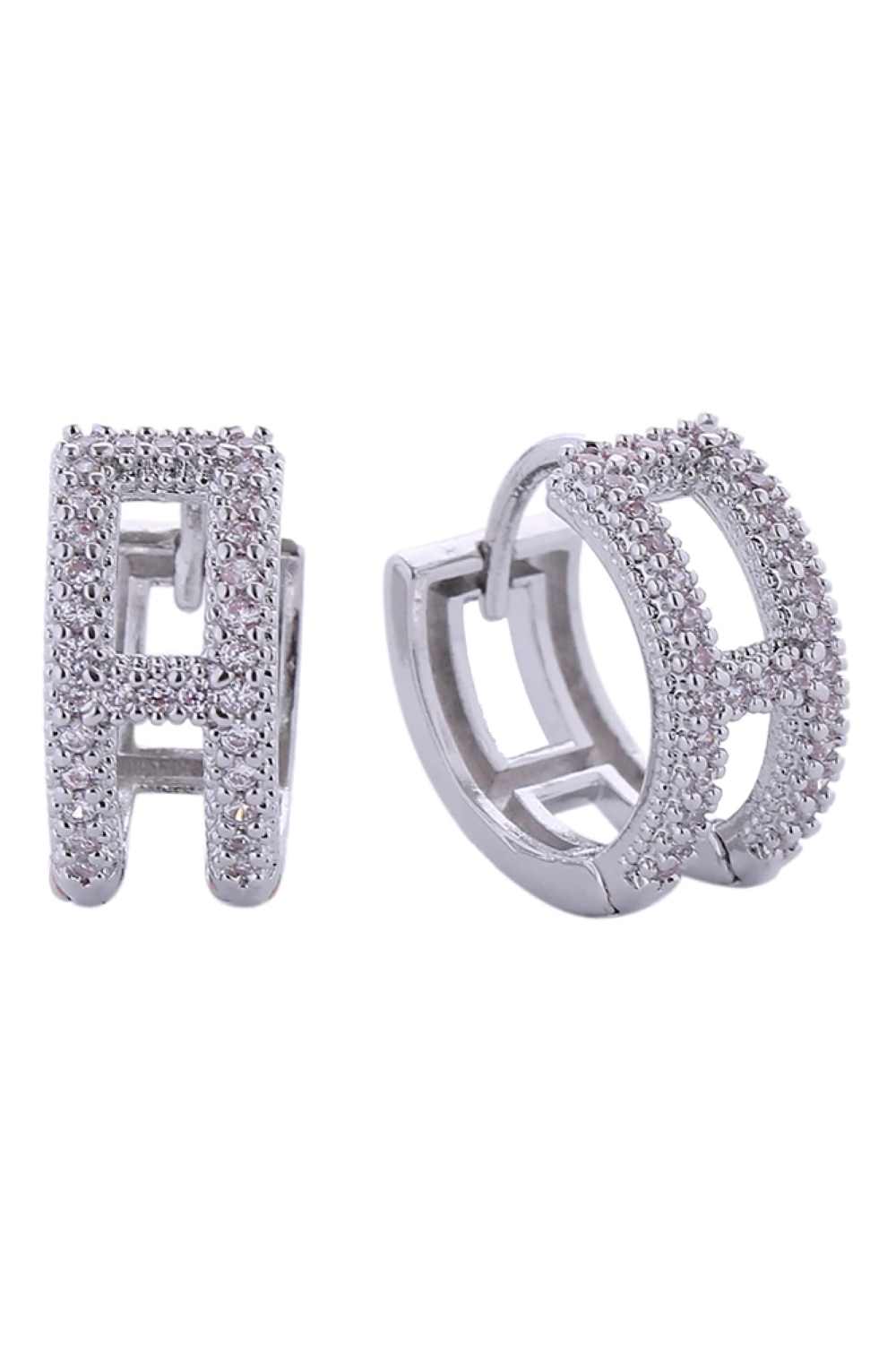 White Gold Elegant huggie earrings featuring the initial H, crafted in brass with 14K gold or white gold dipping. Adorned with sparkling cubic zirconia pavé stones that catch the light beautifully. These hypoallergenic earrings are lead and nickel compliant, making them safe for sensitive ears. With a delicate 1.3cm diameter, they offer a subtle yet sophisticated look perfect for everyday wear or special occasions. Expertly made in Korea, these timeless pieces combine quality craftsmanship with modern style