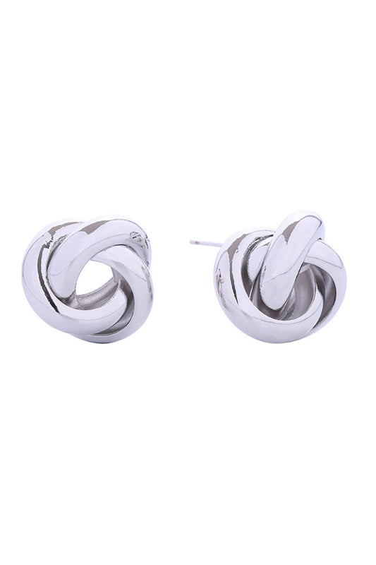 White Gold Elegant love knot post earrings crafted in brass with 14K gold and white gold dipping. These delicate studs measure 2.3cm and feature a timeless knotted design perfect for everyday wear or special occasions. Hypoallergenic construction makes them ideal for sensitive ears. Lead and nickel compliant for peace of mind. Expertly made in Korea with attention to quality craftsmanship.