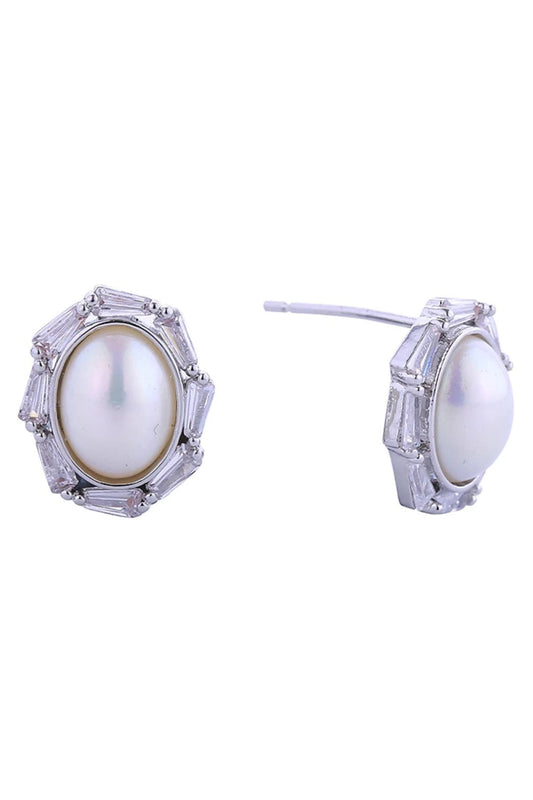 White Gold Elegant oval pearl post earrings crafted in 14K gold and white dipped brass. Sparkling cubic zirconia pavé detailing adds sophisticated glamour to these timeless studs. Measuring 1.1cm in diameter, they're perfectly proportioned for everyday wear or special occasions. Hypoallergenic construction ensures comfort for sensitive ears. Lead and nickel compliant for peace of mind. A versatile addition to any jewelry collection.