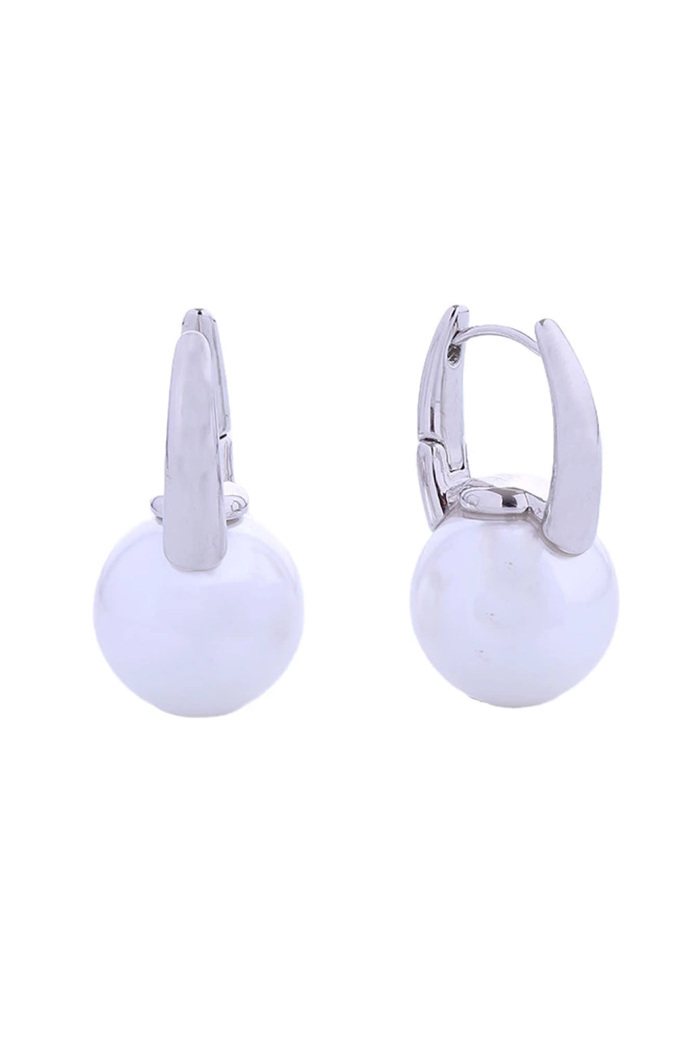 White Gold Elegant pearl drop huggie earrings crafted in 14K gold or white gold-dipped brass. These hypoallergenic earrings feature lustrous pearls suspended from a secure huggie design, perfect for everyday wear or special occasions. Diameter: 1.7cm Lead and nickel compliant for sensitive skin Handcrafted in Korea The timeless combination of pearls and gold creates a versatile piece that complements any style while maintaining comfort throughout the day.