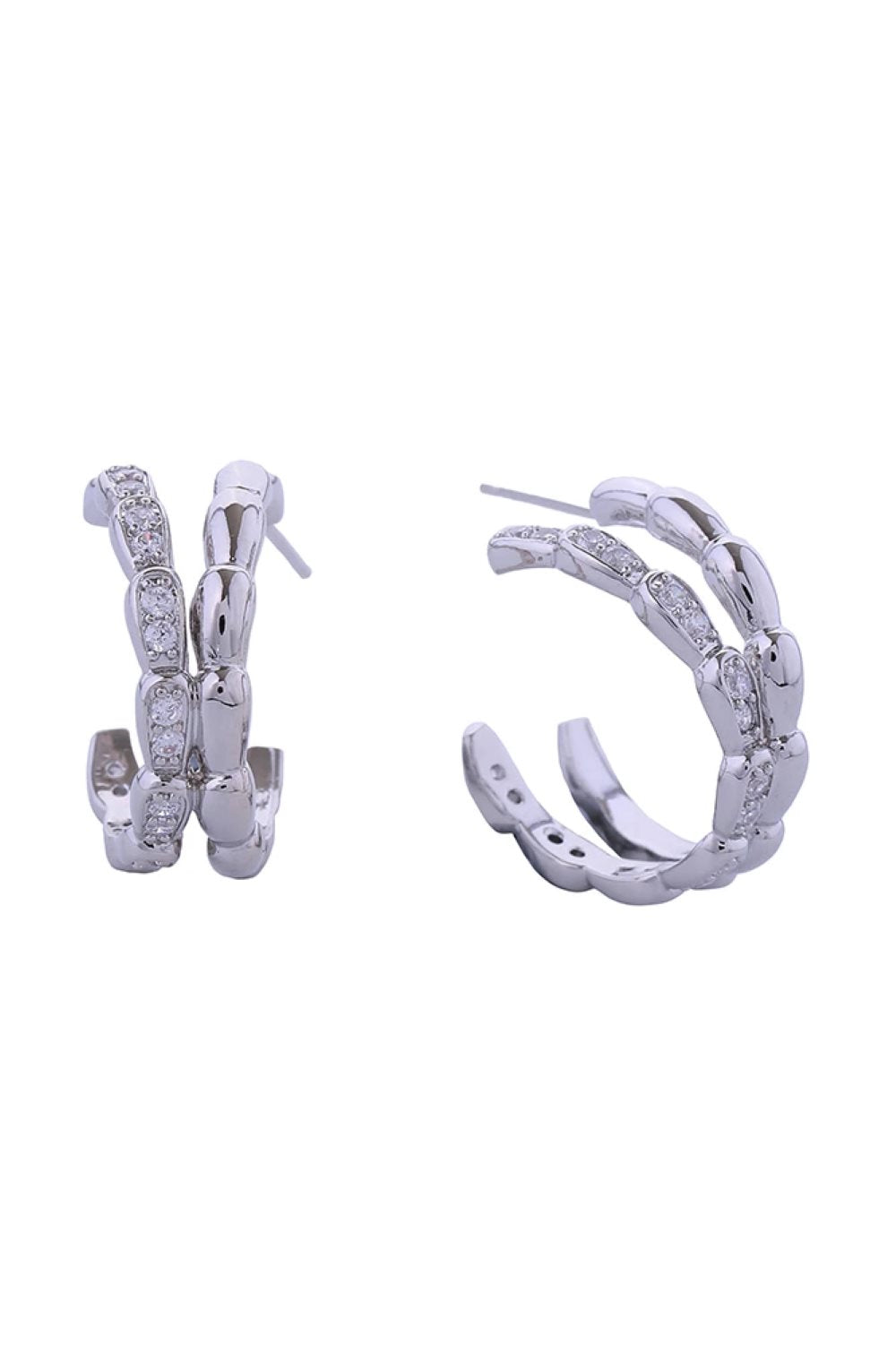 White Gold Elevate your everyday elegance with these stunning 14K Gold/White Dipped Serpenti Pave CZ Post Earrings. Crafted from quality brass and adorned with sparkling cubic zirconia pavé detailing, these 2cm diameter studs deliver timeless sophistication with a modern edge. Designed for comfort and safety, these hypoallergenic earrings are lead and nickel compliant, making them perfect for sensitive skin. The secure post backing ensures they stay in place throughout your day, whether you're heading to th