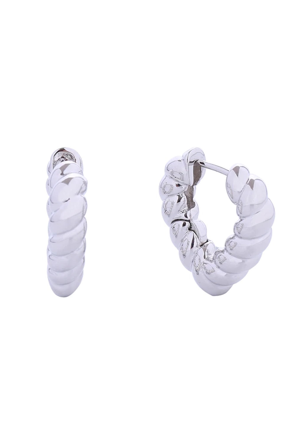 White Gold Delicate twisted heart huggie earrings crafted in hypoallergenic brass with 14K gold and white gold dipping. These petite 2cm earrings hug close to the ear for an elegant, understated look. Lead and nickel compliant for sensitive skin. Expertly made in Korea, they're the perfect everyday accessory or thoughtful gift for someone special.