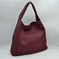 Wine This chic, slouchy shoulder bag features an intricate basket-weave design in a creamy off-white tone, offering a highly textured and relaxed silhouette for stylish everyday use. It is crafted with an integrated wide, woven top handle that extends seamlessly from the main body panels for comfortable over-the-shoulder carrying. The spacious open-top main compartment provides effortless access to your items and comes complete with a matching