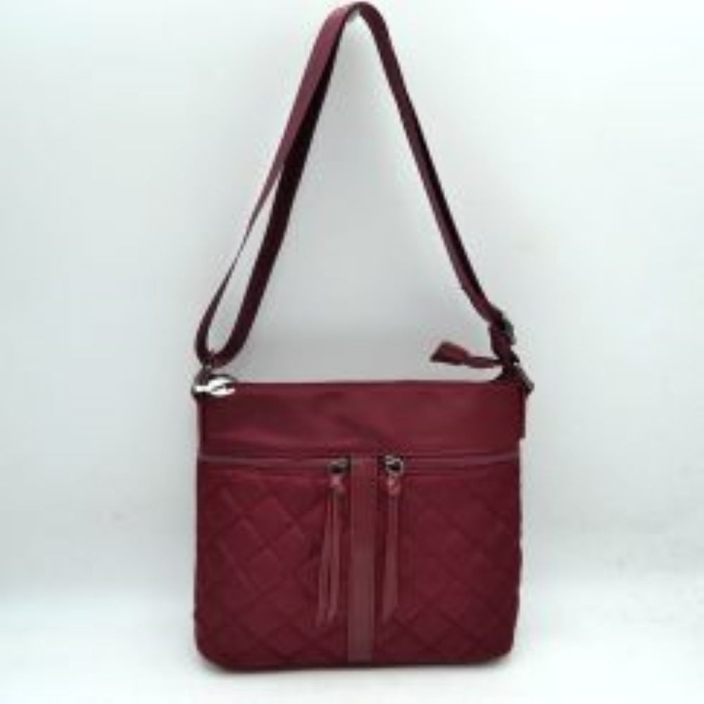 Wine his functional crossbody bag features a dual-texture nylon exterior in a deep navy blue, pairing a smooth upper panel with a classic diamond-quilted lower section. Perfect for organized everyday use, the front is designed with two vertical zipper pockets detailed with long fabric pulls alongside a central decorative stitched strip. Equipped with a secure top zipper closure to keep main compartment essentials safe