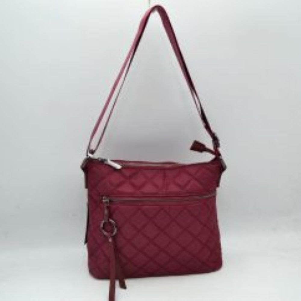 Wine This functional crossbody bag features a classic quilted diamond pattern exterior designed for effortless everyday use. It offers multiple storage compartments, including a main interior section accessed by a top zipper closure and a horizontal front zippered pocket accented by an attached circular ring pull tab. The bag is equipped with a matching flat shoulder strap connected by side loops, featuring an integrated adjustment buckle to easily customize the carrying length.