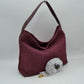Wine This slouchy hobo bag showcases a textured woven pattern across its exterior, offering a refined look that is perfect for everyday use. The spacious main compartment provides ample storage for daily essentials, featuring a relaxed silhouette with a flat top shoulder strap for comfortable carrying. A separate, detachable secondary strap with metallic clasps is included, allowing for versatile styling options to suit your needs.