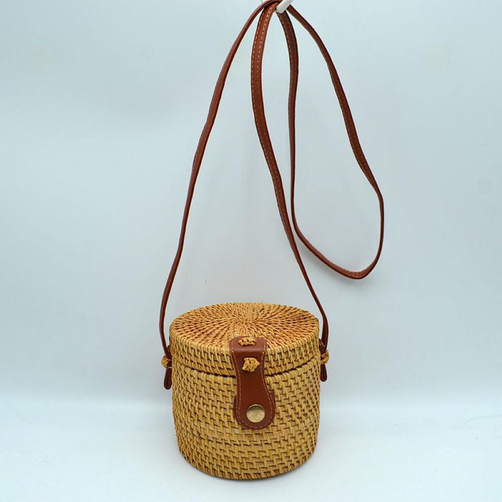 Brown Channel effortless, sun-drenched style with this unique structured cylinder crossbody bag. Featuring a beautiful bohemian aesthetic, this hand-woven barrel bag adds a natural, artisanal touch to any summer look, vacation outfit, or casual weekend style.