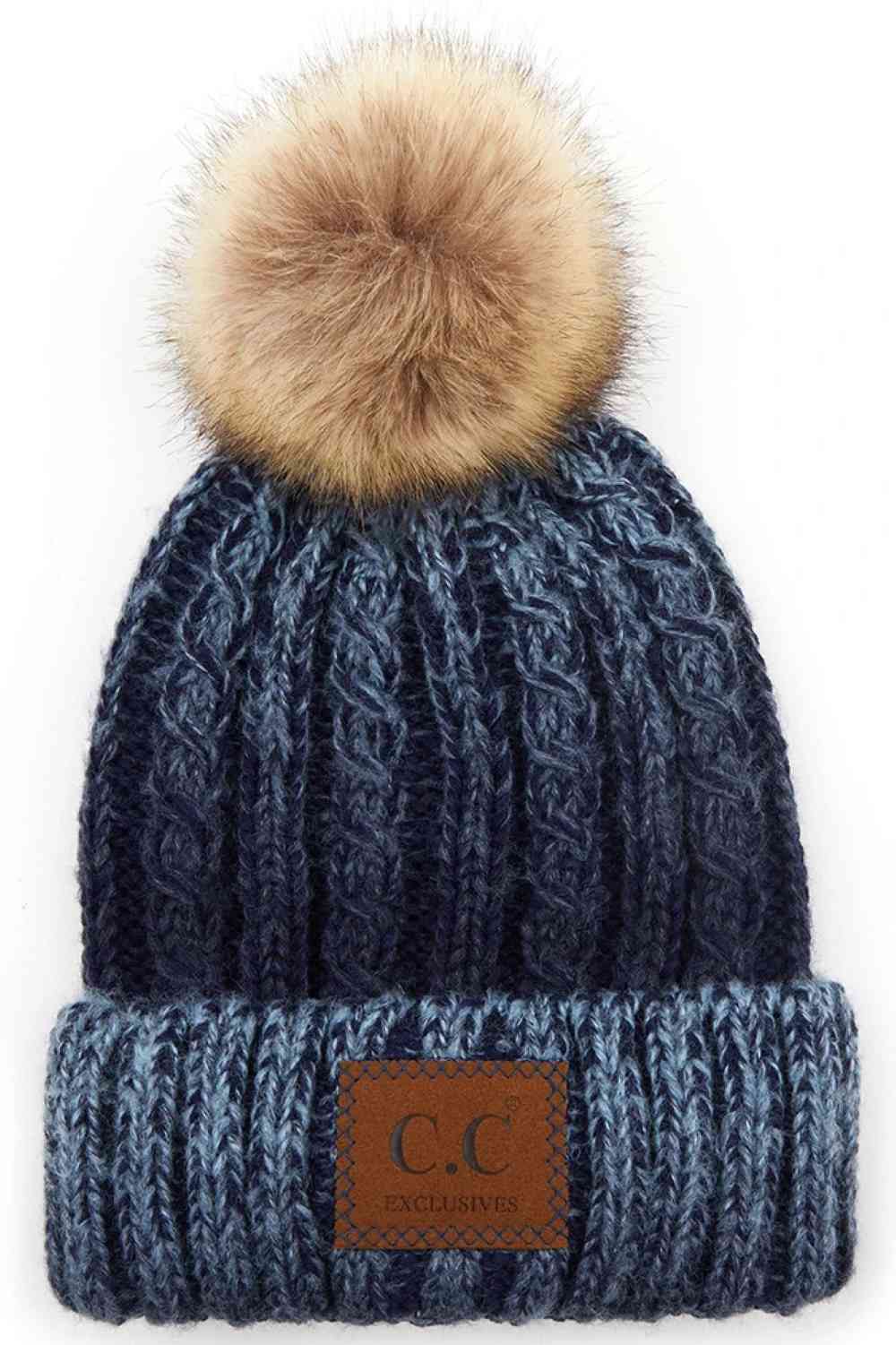 Navy Elevate your winter wardrobe with this C.C ombre beanie featuring a plush faux fur pom. Crafted from 100% acrylic, the soft knit construction provides warmth and comfort without bulk. Perfect for casual outings or layering under winter gear.