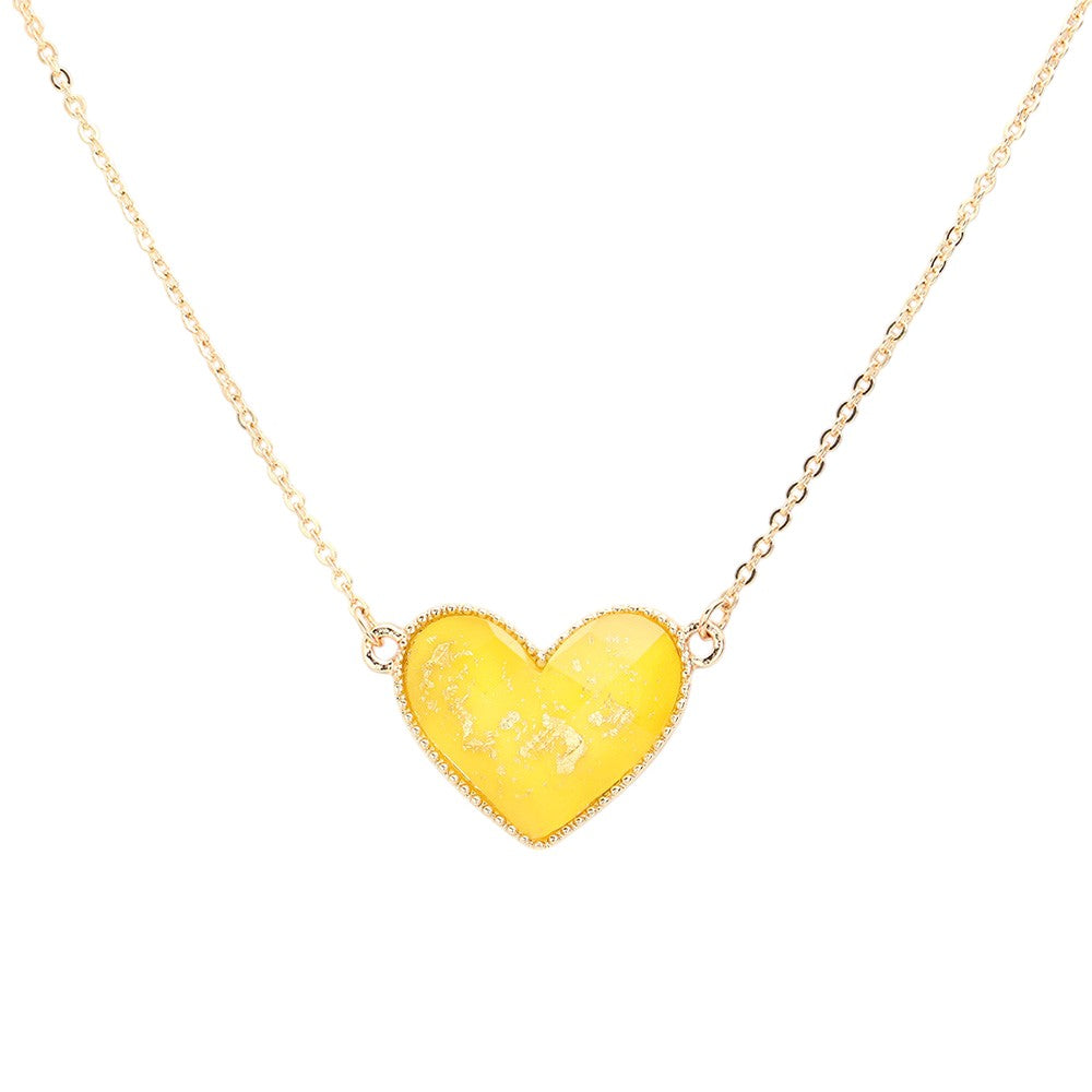 Yellow Gold Foil Detailed Heart Pendant Necklace adds a touch of elegance to any outfit. The intricate gold foil detailing highlights the delicate heart pendant, creating a timeless and sophisticated piece. Crafted with high-quality materials, this necklace is sure to make a statement and elevate your style.