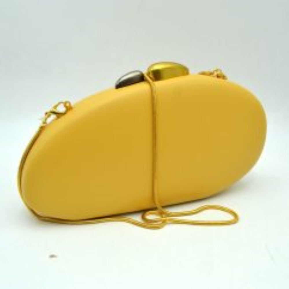 Yellow This structured hardcase clutch bag features a smooth, rounded oval silhouette designed as a sleek accessory for everyday use. Its single interior storage compartment is secured with a rigid frame closure, accented at the top by a distinctive, asymmetrical two-tone sculptural clasp. A slender, matching metallic snake chain strap connects to small loop anchors on either side via clasp attachments, offering convenient options for hands-free shoulder or crossbody styling.