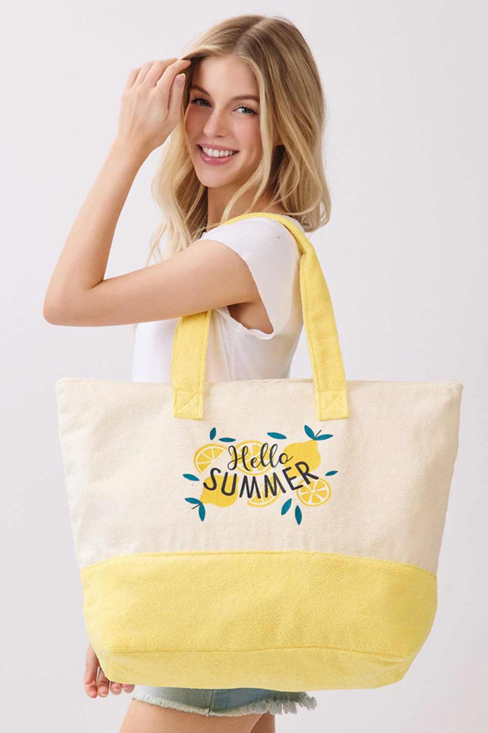 Yellow Brighten your summer days with this cheerful HELLO SUMMER tote bag, featuring a playful lemon print design. Crafted from a durable polyester and polyamide blend, this spacious 22" x 16" x 6" bag is perfect for beach trips, farmers markets, or everyday errands. The secure zipper closure keeps your essentials safe, while the convenient inner pocket adds extra organization. Whether you're heading out for the season or looking for a vibrant accessory, this terry tote combines style and functionality in o