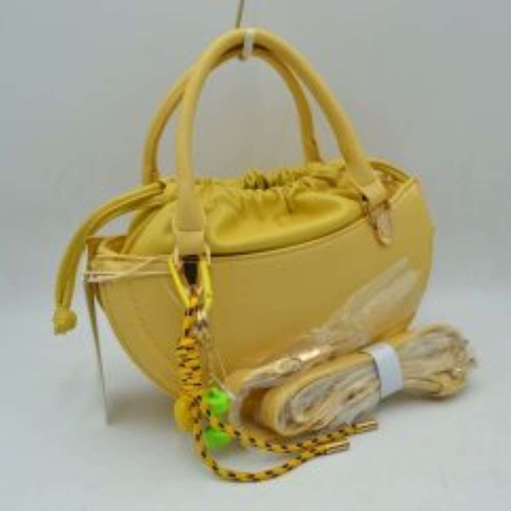Yellow This everyday handbag showcases a structured crescent silhouette with a distinctive curved profile. Designed for versatility, it features dual rounded top handles alongside a detachable and adjustable long shoulder strap secured by metallic hardware. The interior storage includes a gathered inner pouch with a functional drawstring closure, while the outer shell forms an additional open compartment for quick-access items.