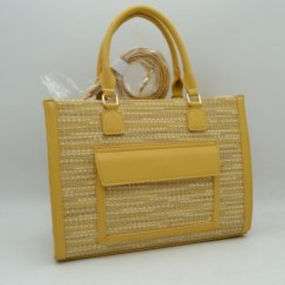 Yellow Bring a polished, professional edge to your daily commute with this beautifully structured rectangular tote bag. Showcasing a refined, multi-tonal woven tweed patterned exterior, this handbag is sharply framed by clean, solid-colored vertical trim and a matching protective base that effortlessly retains its crisp silhouette. The front features a prominent, smooth-textured slip pocket with a protective overhanging flap, offering convenient, easy-access storage for smaller items like keys or commuter p