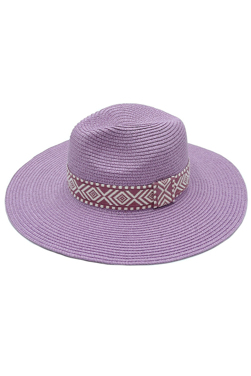 Lavender AZTEC BAND PANAMA HAT features a distinctive Aztec band, combining traditional weaving techniques with cultural artistry. The tightly woven natural fibres create exceptional durability while maintaining breathability for temperature regulation. The precisely angled brim offers optimal sun protection without compromising style. Each hat exhibits subtle variations, reflecting its handcrafted nature and superior craftsmanship—an investment piece for the sophisticated wardrobe. 