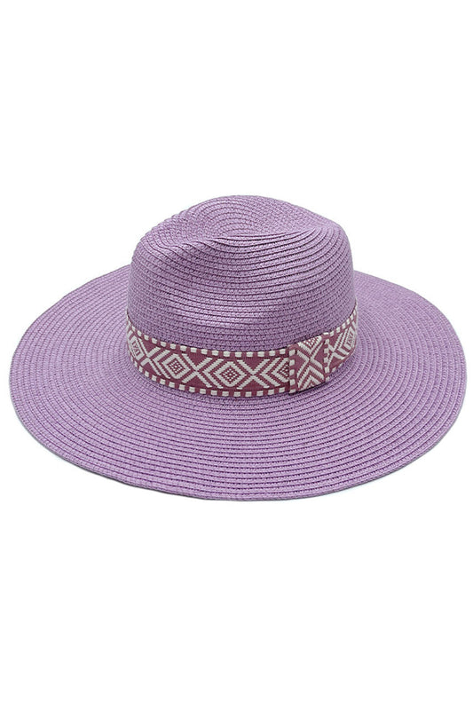 Lavender AZTEC BAND PANAMA HAT features a distinctive Aztec band, combining traditional weaving techniques with cultural artistry. The tightly woven natural fibres create exceptional durability while maintaining breathability for temperature regulation. The precisely angled brim offers optimal sun protection without compromising style. Each hat exhibits subtle variations, reflecting its handcrafted nature and superior craftsmanship—an investment piece for the sophisticated wardrobe. 