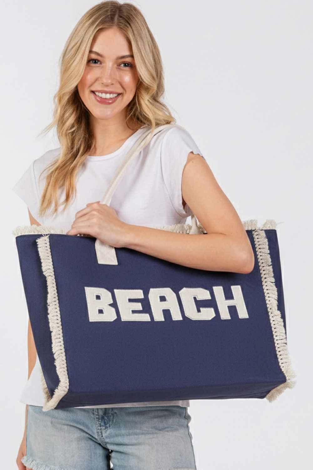 Denim BEACH Embroidered Letter Fringe Summer Tote Bag combines style and practicality for your warm-weather outings. Crafted with durable materials, it features detailed embroidered lettering and playful fringe accents that enhance its summery appeal. Spacious enough to carry essentials, this tote is perfect for beach days or casual errands, offering both functionality and a distinctive, expert-crafted design.