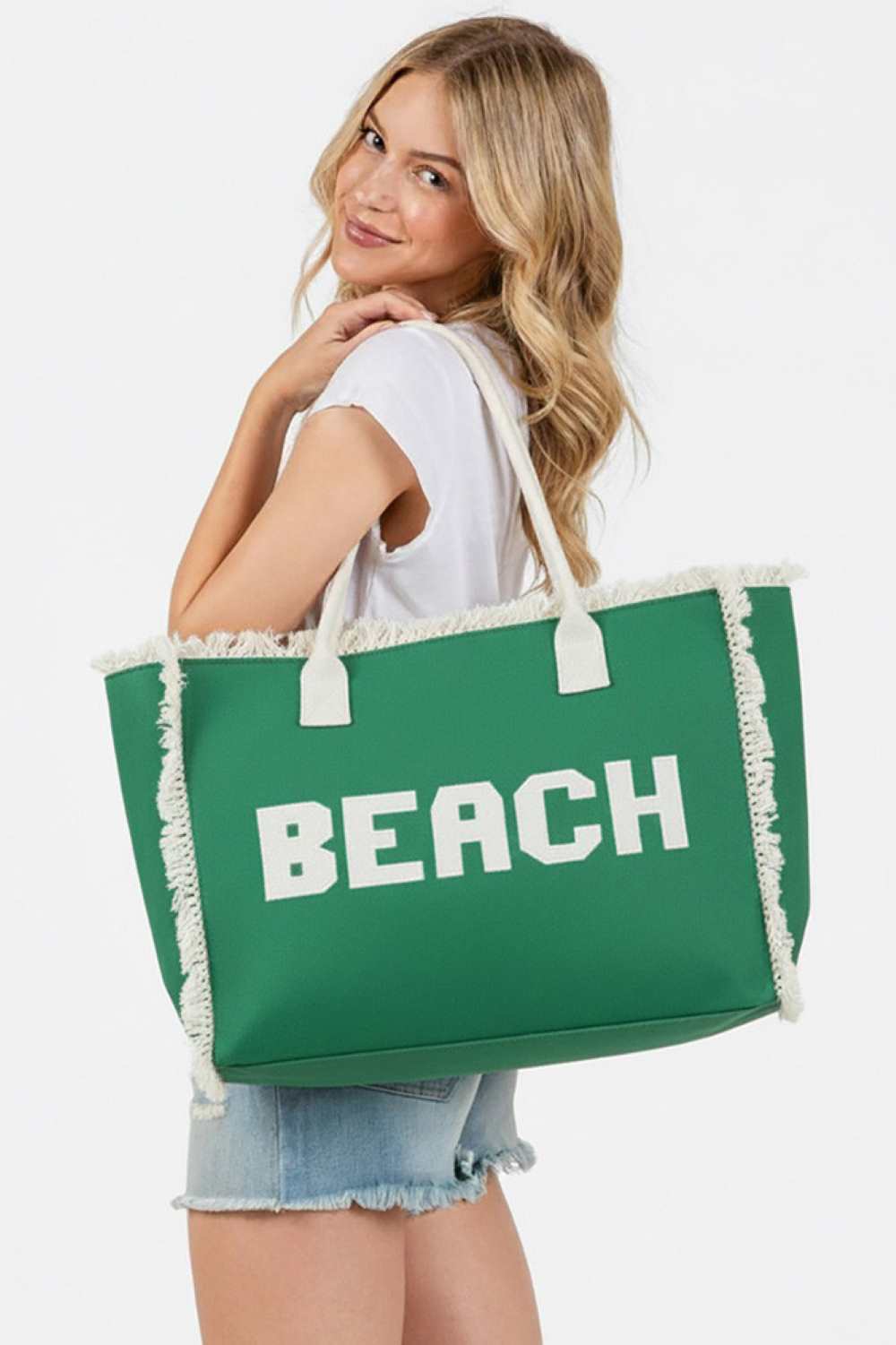 Green BEACH Embroidered Letter Fringe Summer Tote Bag combines style and practicality for your warm-weather outings. Crafted with durable materials, it features detailed embroidered lettering and playful fringe accents that enhance its summery appeal. Spacious enough to carry essentials, this tote is perfect for beach days or casual errands, offering both functionality and a distinctive, expert-crafted design.