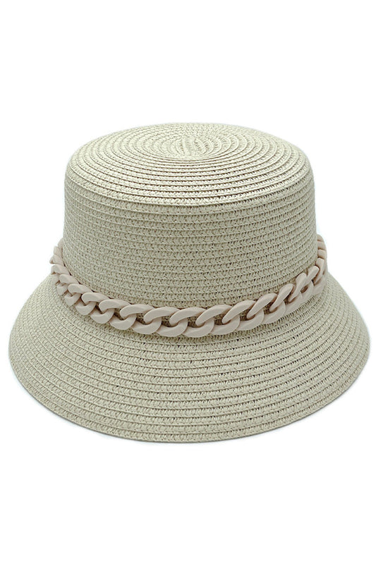 Beige CHAIN BAND STRAW BUCKET HAT features an integrated chain band detail that creates a sophisticated tension between natural and metallic elements. The specialized weave density provides UPF protection while maintaining optimal breathability through strategically placed ventilation points. Its ergonomically designed interior ensures a consistent fit across head sizes, while the calculated brim curvature delivers maximum facial coverage without distorting peripheral vision—an exemplary balance of technica