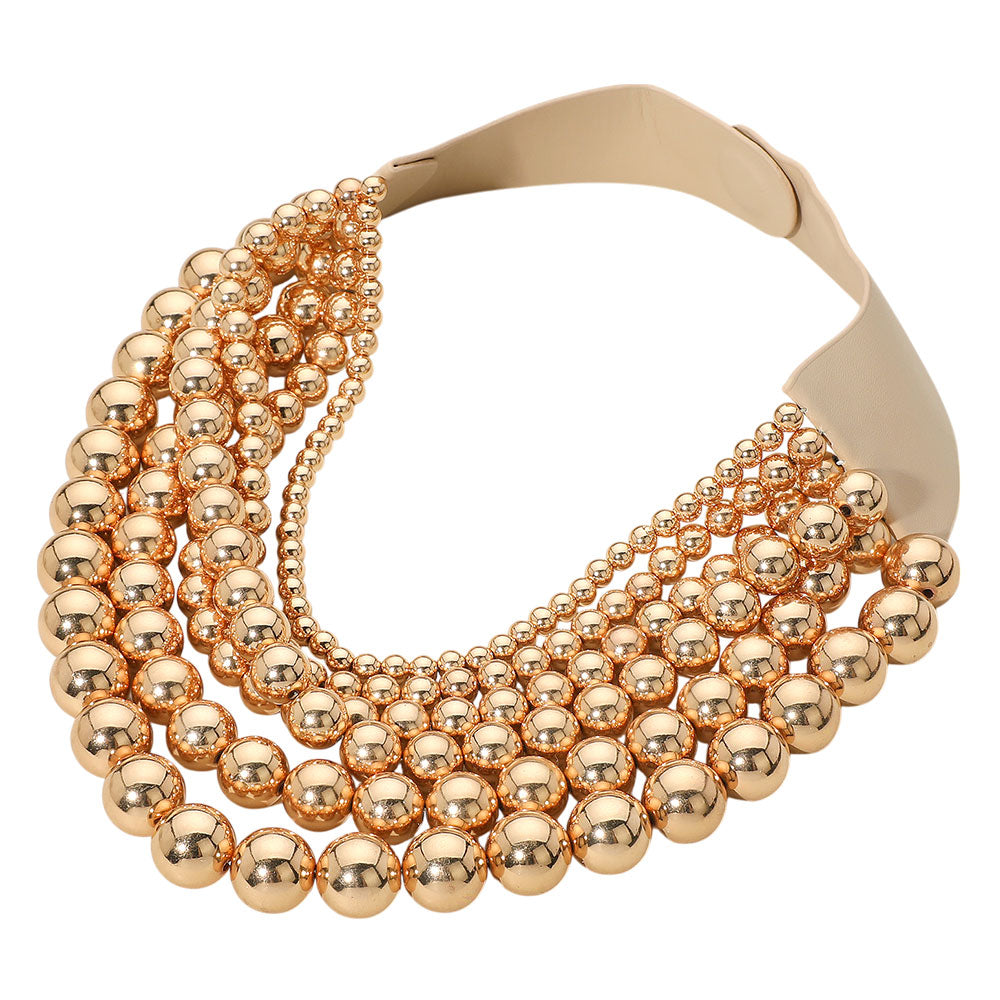 Gold Chunky Metal Ball Beaded Multi-Layered Faux Leather Magnetic Necklace combines bold design with functional elegance. Crafted with layered faux leather strands accented by substantial metal ball beads, it delivers a textured, contemporary look. The magnetic clasp provides secure, easy fastening, enhancing wearability without compromising style. Ideal for professionals seeking a statement accessory that balances durability and modern sophistication. 