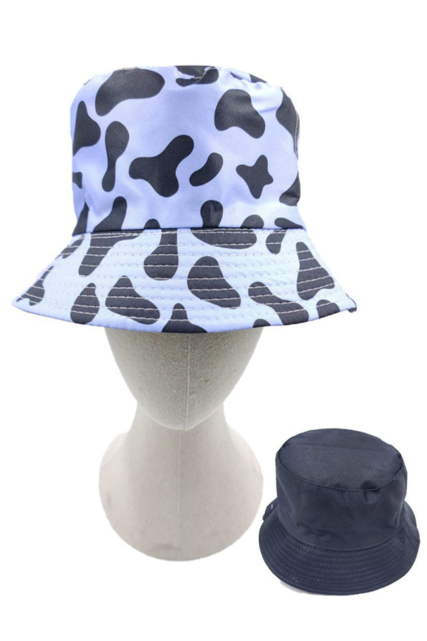 Blue Cow Print Reversible Bucket Hat features a precisely rendered cow print pattern with carefully calculated spot distribution for maximum visual definition. Constructed using advanced textile composites that deliver exceptional UV protection while maintaining optimal thermal regulation properties. Reinforced seam architecture ensures dimensional stability throughout repeated wear cycles, while the structurally engineered brim provides consistent shade coverage without compromising integrity. 