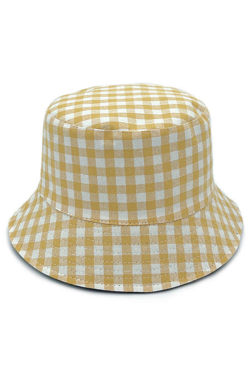 Yellow GINGHAM REVERSIBLE BUCKET HAT delivers dual-wear functionality with a traditional gingham pattern on one side and complementary solid fabric on the reverse. Constructed with premium materials for structural integrity while maintaining breathability. The versatile silhouette provides effective UV protection while complementing various style aesthetics for year-round wear.