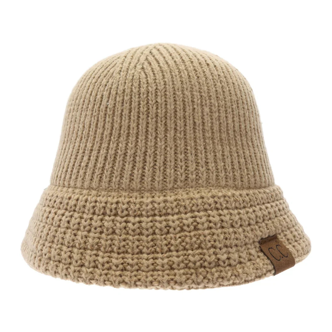 Dark Nude Knitted Cloche C.C Bucket Hat combines classic cloche styling with the casual appeal of a bucket hat, crafted from soft, durable knit fabric. Its structured yet flexible design offers comfortable wear and a flattering fit, making it an ideal accessory for cooler seasons. This hat offers both warmth and style, making it perfect for adding a sophisticated edge to everyday outfits. 