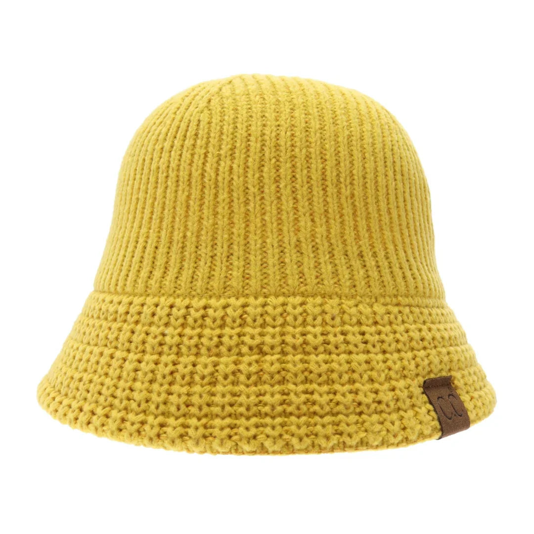 Mustard Knitted Cloche C.C Bucket Hat combines classic cloche styling with the casual appeal of a bucket hat, crafted from soft, durable knit fabric. Its structured yet flexible design offers comfortable wear and a flattering fit, making it an ideal accessory for cooler seasons. This hat offers both warmth and style, making it perfect for adding a sophisticated edge to everyday outfits. 