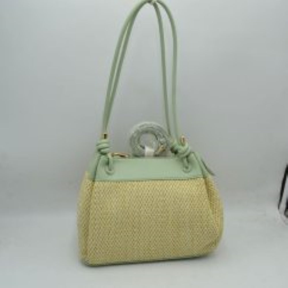 Mint Embrace a relaxed yet sophisticated aesthetic with this beautifully textured shoulder bag. The design prominently features a classic woven mesh panel across the main body, paired seamlessly with smooth trim along the upper edge and base. Dual slender shoulder straps attach to the bag with elegant, integrated knot details at the base, offering a comfortable drop for easy over-the-shoulder carrying. 
