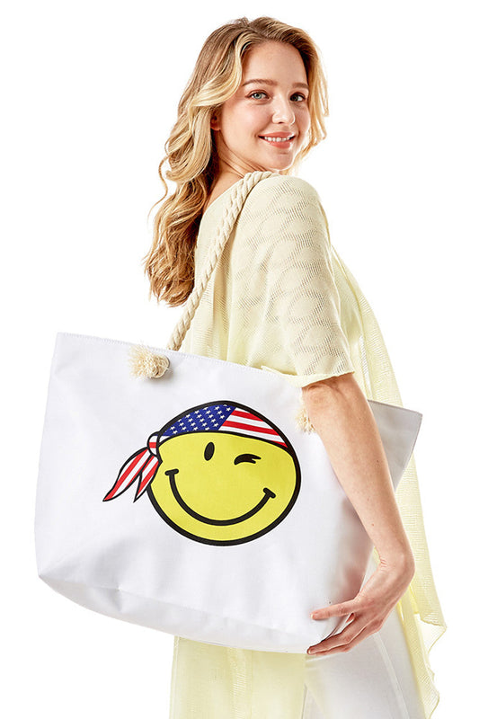 Smiley Face with USA Bandana American Flag Theme Beach Bag features a cheerful smiley face adorned with a USA bandana in an American flag theme, combining patriotic style with practical design. Crafted for durability and spaciousness, it offers ample room for all your beach essentials while making a bold statement. Ideal for summer outings, this bag blends festive flair with everyday functionality. 