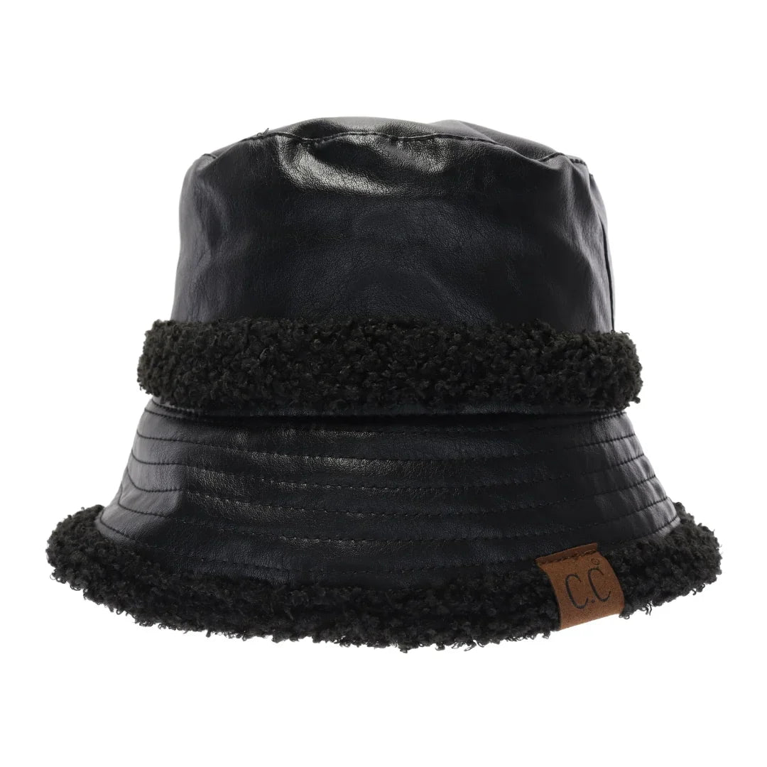 Black Soft Faux Leather Shearling C.C Bucket Hat combines premium faux leather with a plush shearling lining to deliver exceptional warmth and comfort. Designed with a classic bucket silhouette, this hat offers a refined, expert-level accessory that enhances cold-weather outfits while providing durable protection against the elements. Its soft texture and thoughtful construction make it a sophisticated choice for those seeking both style and functionality. 