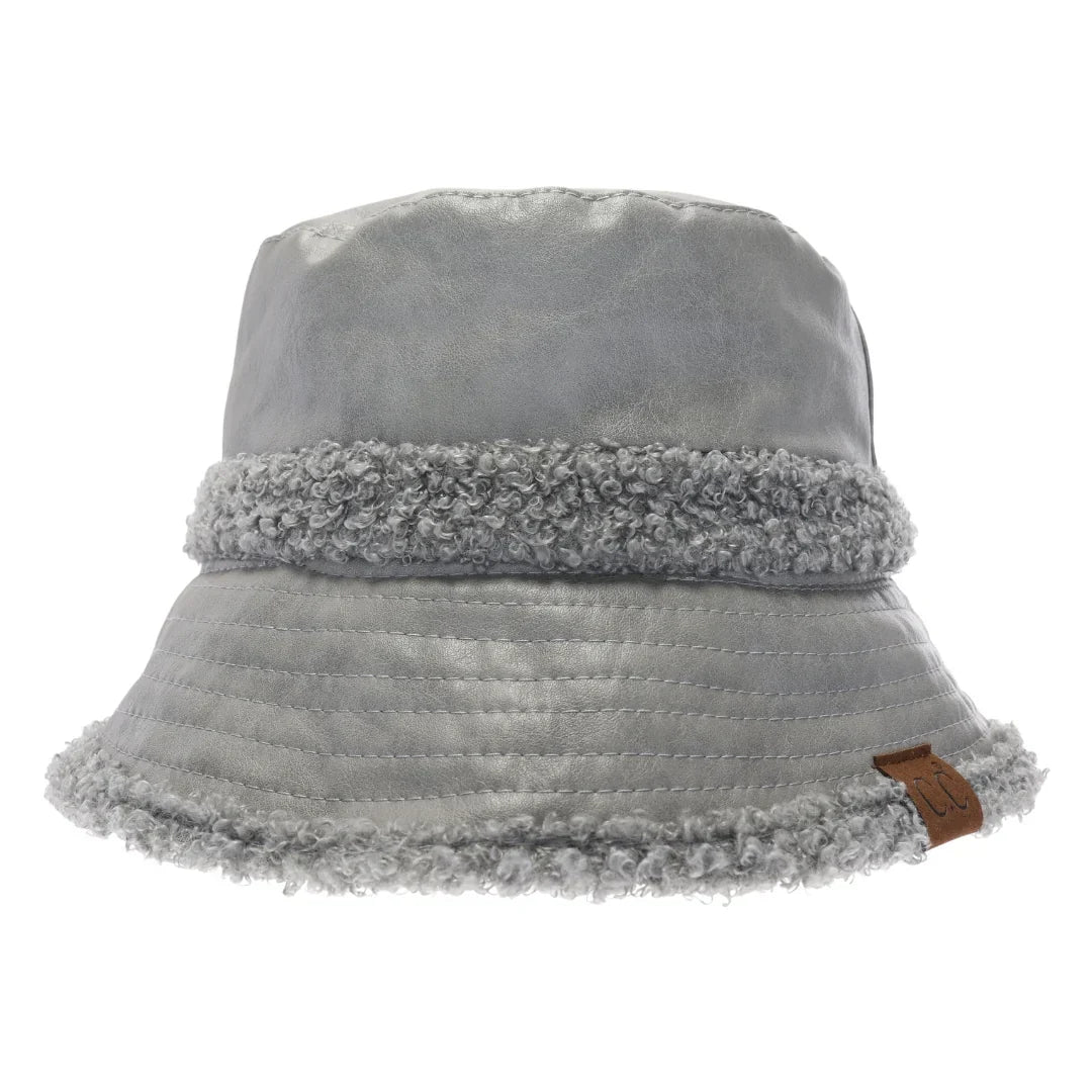 Grey Soft Faux Leather Shearling C.C Bucket Hat combines premium faux leather with a plush shearling lining to deliver exceptional warmth and comfort. Designed with a classic bucket silhouette, this hat offers a refined, expert-level accessory that enhances cold-weather outfits while providing durable protection against the elements. Its soft texture and thoughtful construction make it a sophisticated choice for those seeking both style and functionality. 