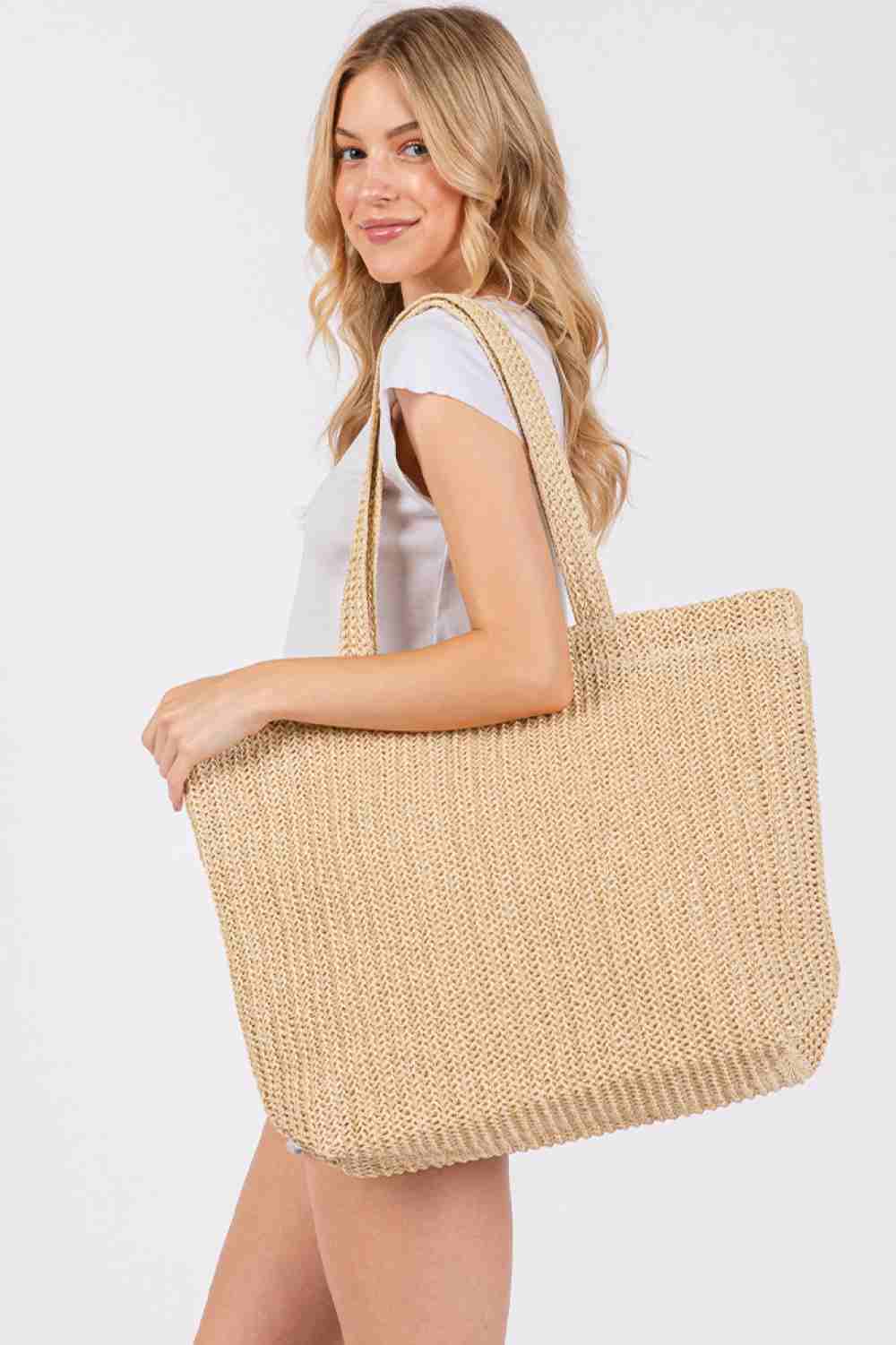Beige Solid Color Crochet Summer Straw Tote Bag combines timeless craftsmanship with practical design. Handwoven from durable straw, its crochet pattern offers breathability and lightweight comfort, making it ideal for warm-weather outings. The spacious interior accommodates essentials effortlessly, while the sturdy handles ensure easy carrying. Perfect for beach trips, casual strolls, or everyday use, this tote blends style and function for a refined summer accessory.