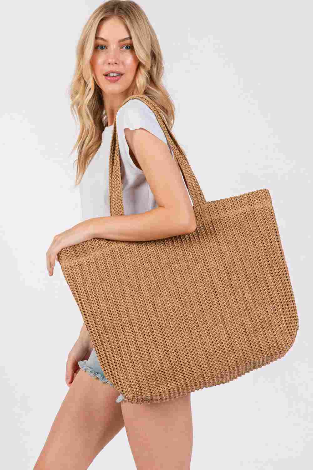 Taupe Solid Color Crochet Summer Straw Tote Bag combines timeless craftsmanship with practical design. Handwoven from durable straw, its crochet pattern offers breathability and lightweight comfort, making it ideal for warm-weather outings. The spacious interior accommodates essentials effortlessly, while the sturdy handles ensure easy carrying. Perfect for beach trips, casual strolls, or everyday use, this tote blends style and function for a refined summer accessory.