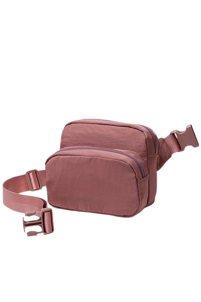 Solid Double Zipper Fanny Pack offers practical organization with two separate compartments, allowing you to store essentials while keeping them easily accessible and secure. Its durable construction ensures long-lasting use, making it ideal for travel, outdoor activities, or daily errands. The adjustable strap provides a comfortable fit, combining convenience and functionality in a sleek, minimalist design.