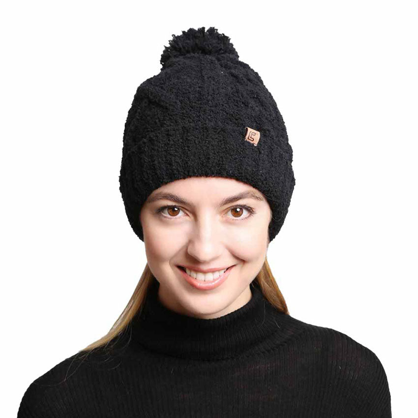 Black Solid Color Cable Knit Beanie. Accessorize the fun way with this pom cable knit Beanie. The autumnal touch you need to finish your outfit in style. Cable knit Beanie made with warm poly microfiber to ensure maximum comfort and durability. Ideal winter head cover! Comes in one size winter cap with a pom that fits most head sizes. Absolutely the perfect gift winter accessory!