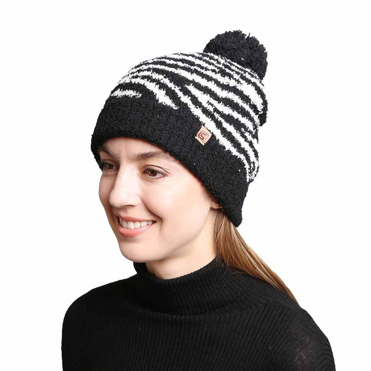 Black Zebra Lined Pom Pom Beanie. These awesome trendy women’s Beanie With Faux Fur Pom are Warm, durable and comfortable. This will be your go-to beanie this fall and winter season. These zebra themed beannie has classic style that allows you to enhance your outfit, no matter your wardrobe. Accessorize the fun way with this faux fur pom pom hat, Awesome winter gift accessory! Perfect Gift Birthday, Christmas, Stocking Stuffer, Secret Santa, Holiday, Anniversary, Valentine's Day, Loved One.
