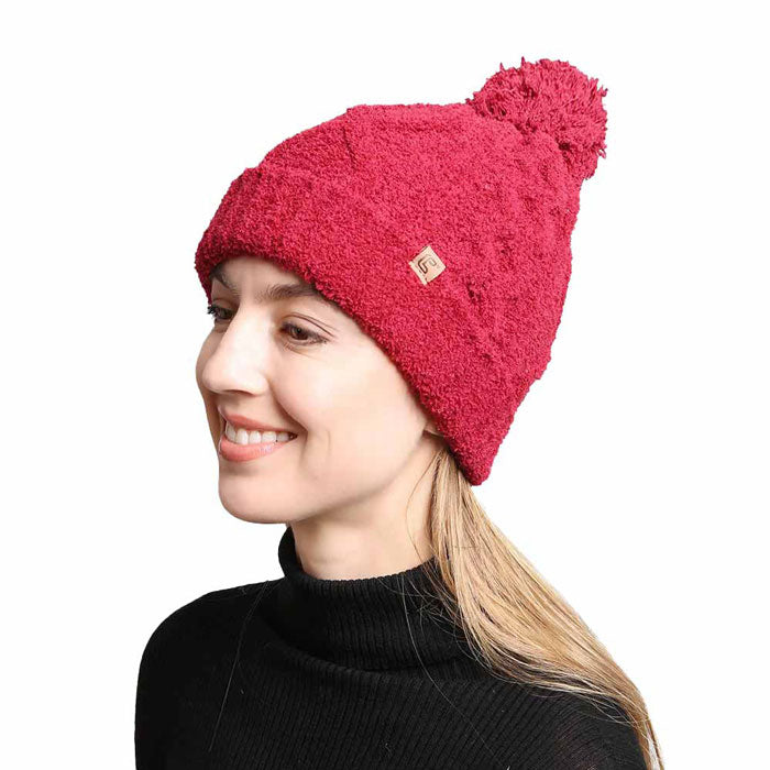 Burgundy Solid Color Cable Knit Beanie. Accessorize the fun way with this pom cable knit Beanie. The autumnal touch you need to finish your outfit in style. Cable knit Beanie made with warm poly microfiber to ensure maximum comfort and durability. Ideal winter head cover! Comes in one size winter cap with a pom that fits most head sizes. Absolutely the perfect gift winter accessory!