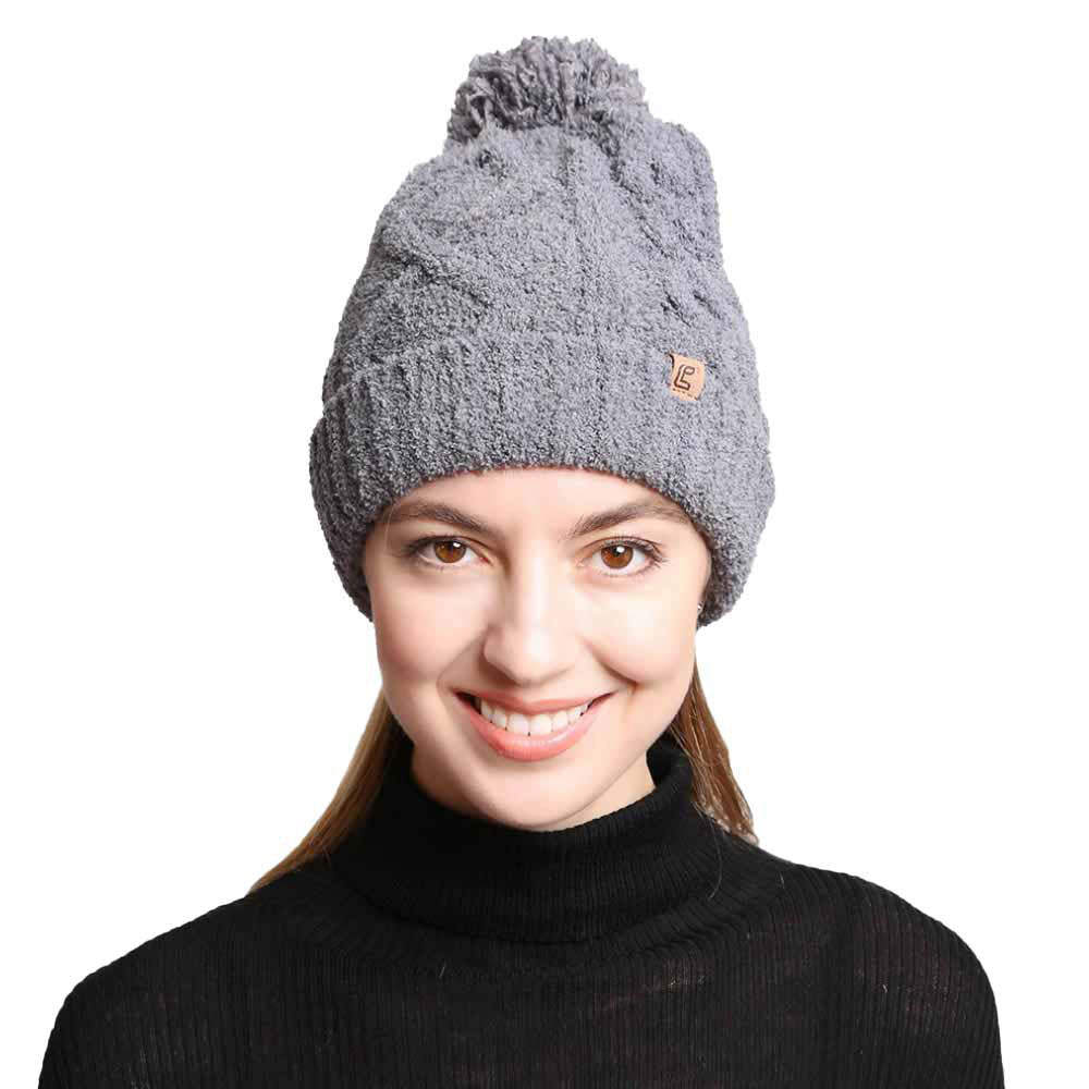 Gray Solid Color Cable Knit Beanie. Accessorize the fun way with this pom cable knit Beanie. The autumnal touch you need to finish your outfit in style. Cable knit Beanie made with warm poly microfiber to ensure maximum comfort and durability. Ideal winter head cover! Comes in one size winter cap with a pom that fits most head sizes. Absolutely the perfect gift winter accessory!