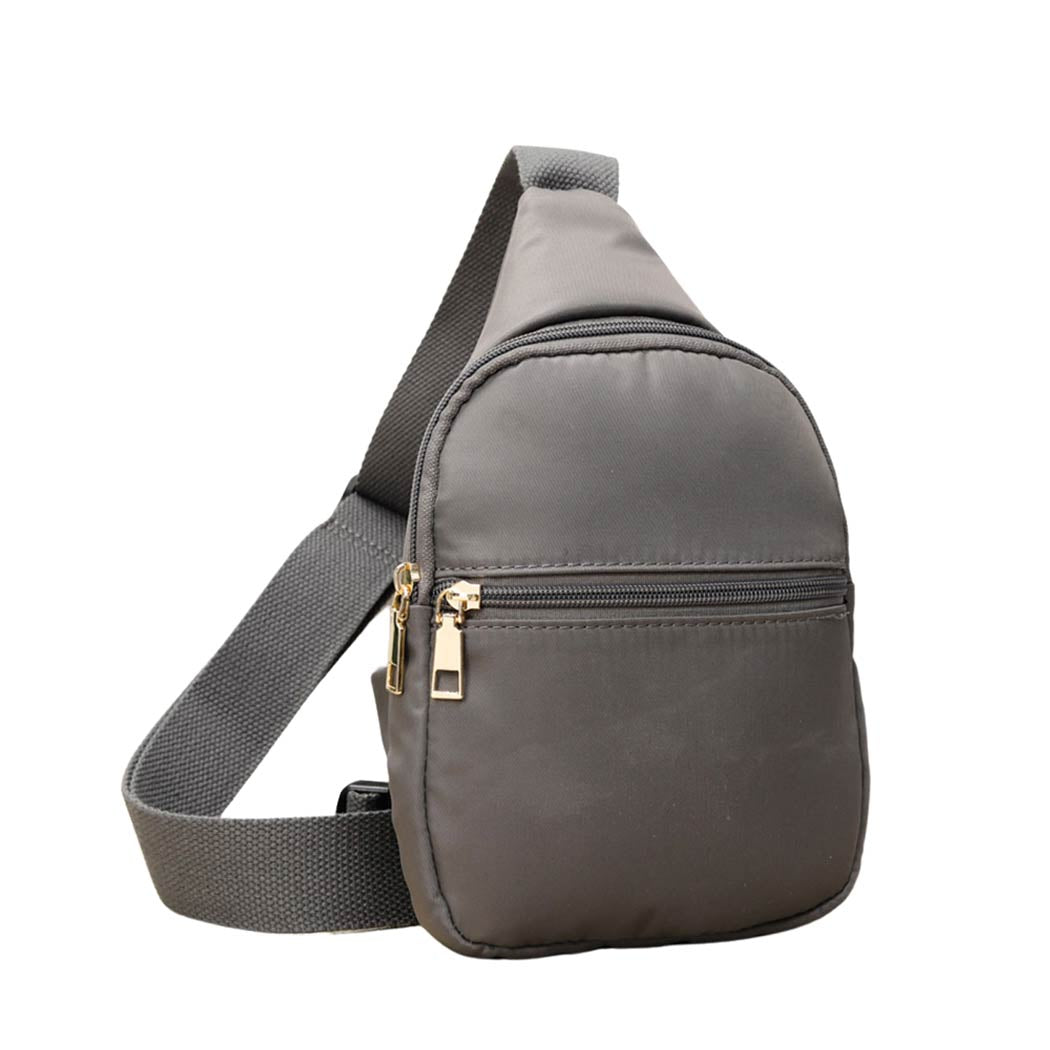 Gray Solid Nylon Mini Sling Bag, be the ultimate fashionista while carrying this Solid Nylon Mini Sling bag in style. It's great for carrying small and handy things. Keep your keys handy & ready for opening doors as soon as you arrive. The adjustable lightweight features room to carry what you need for those longer walks or trips.